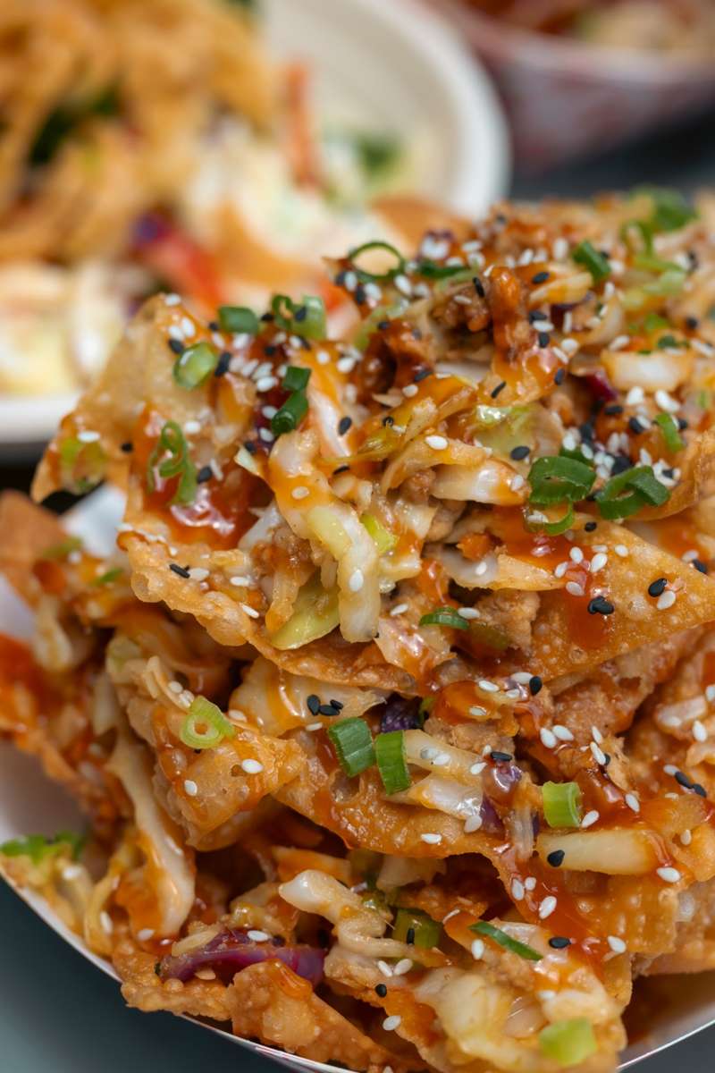 Inside-Out Eggroll topped with slaw, sauce and green onions