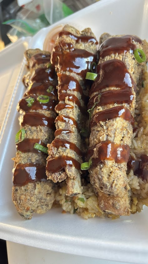 The Wok Lobster Southern Fried Ribs with sauce and green onions served over fried rice — original restaurant photo
